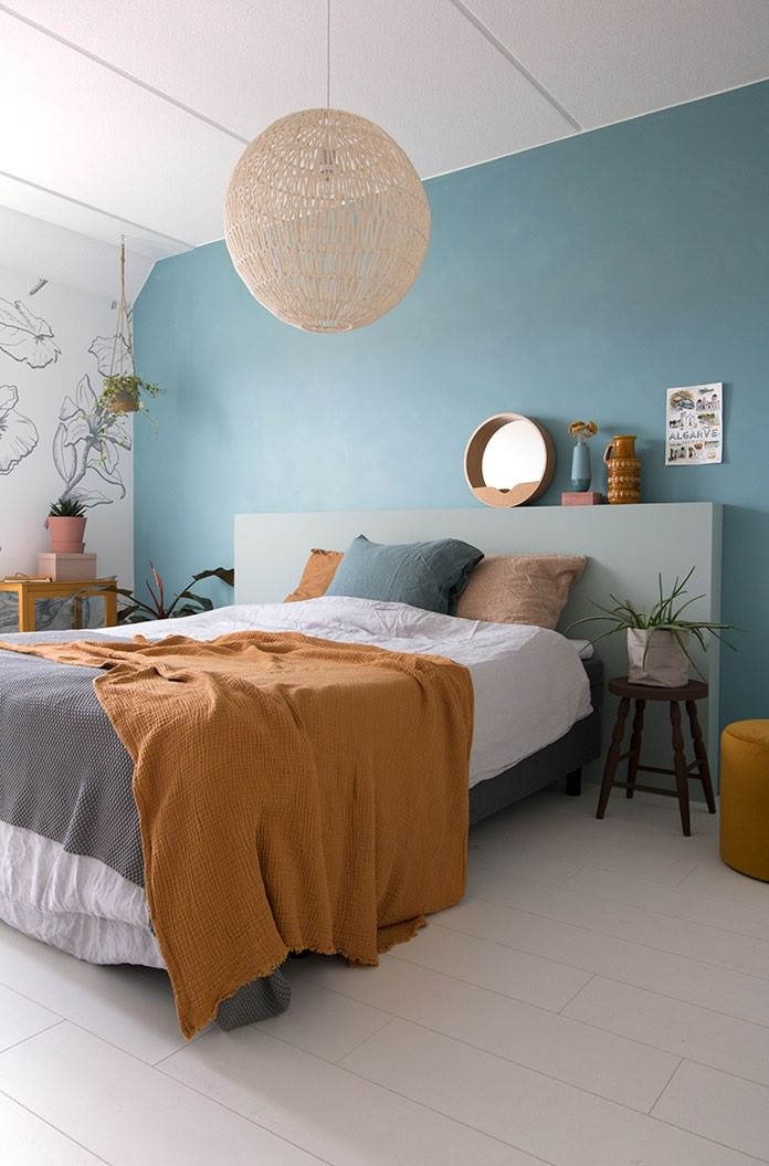 دکوراسیون آبی و زرد اتاق خواب که دیوار تاکیدی آن آبی و اکسسوری و روتختی زرد دارد
