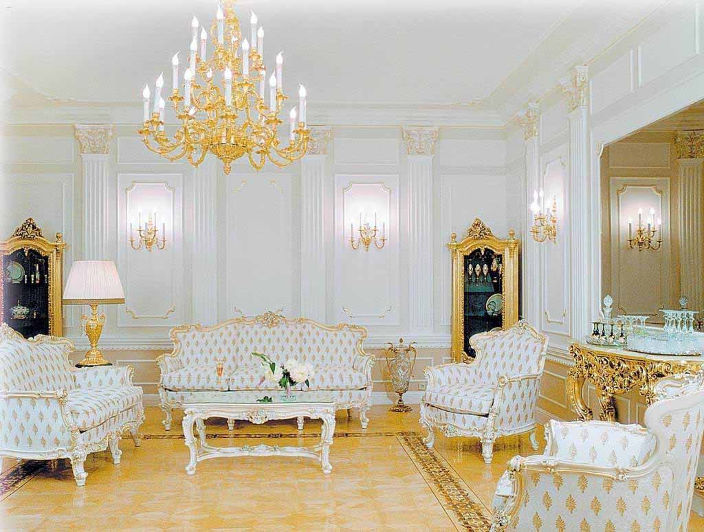 دکوراسیون سفید طلایی پذیرایی کلاسیک با قبا بندی و دیوار کوب و لوستر طلایی