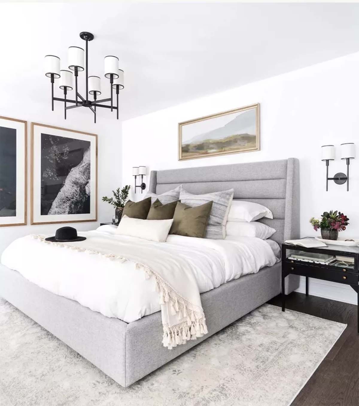 اتاق خواب طوسی سفید با تخت طوسی و دیوار سفید و کف چوبی و تابلوهای طرح دار